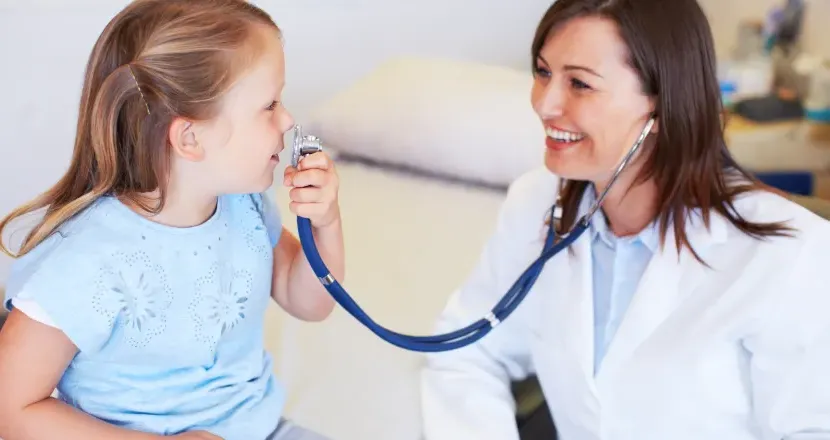 Pediatric Nurse Practitioner Smiling with Young Patient